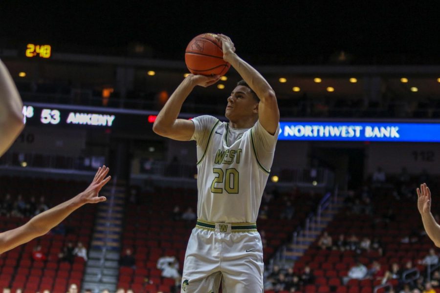 Marcus Morgan '21 knocks down a three pointer during the state quarterfinal on March 11.