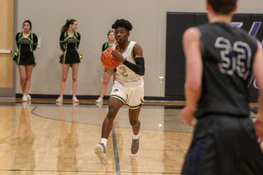 Christian Barnes '22 pushes the ball up the floor against Pleasant Valley on March 3.