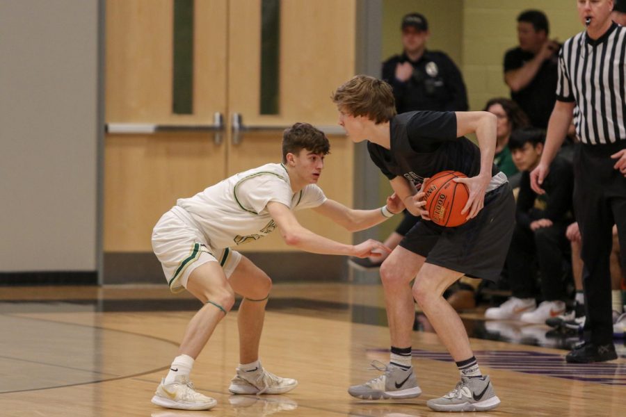 Joe Goodman '20 looks for a steal against Pleasant Valley on March 3.