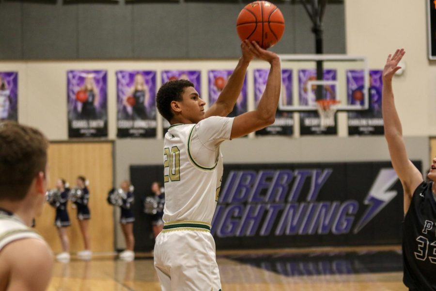  Marcus Morgan '21 knocks down a three against Pleasant Valley on March 3.