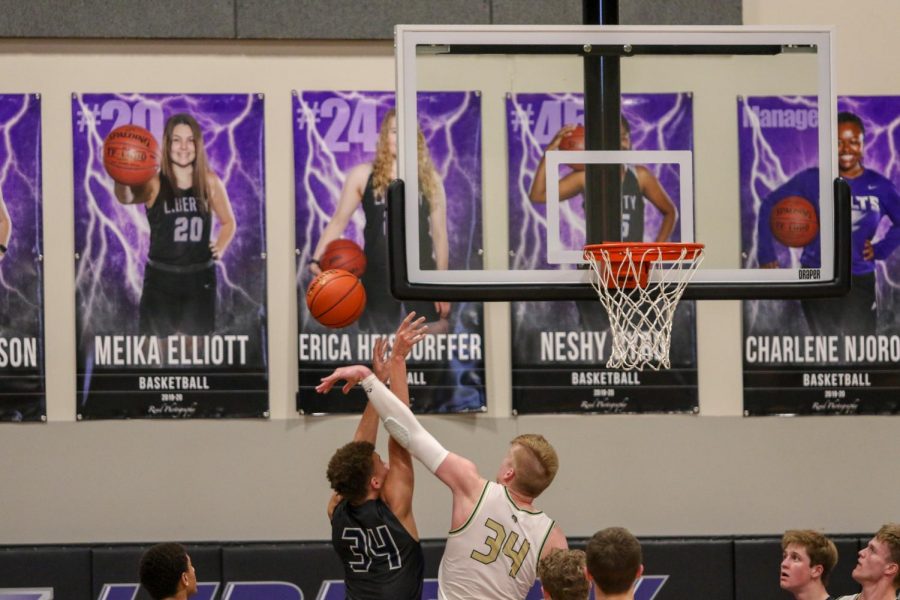 Even Brauns '20 blocks a shot against Pleasant Valley on March 3.