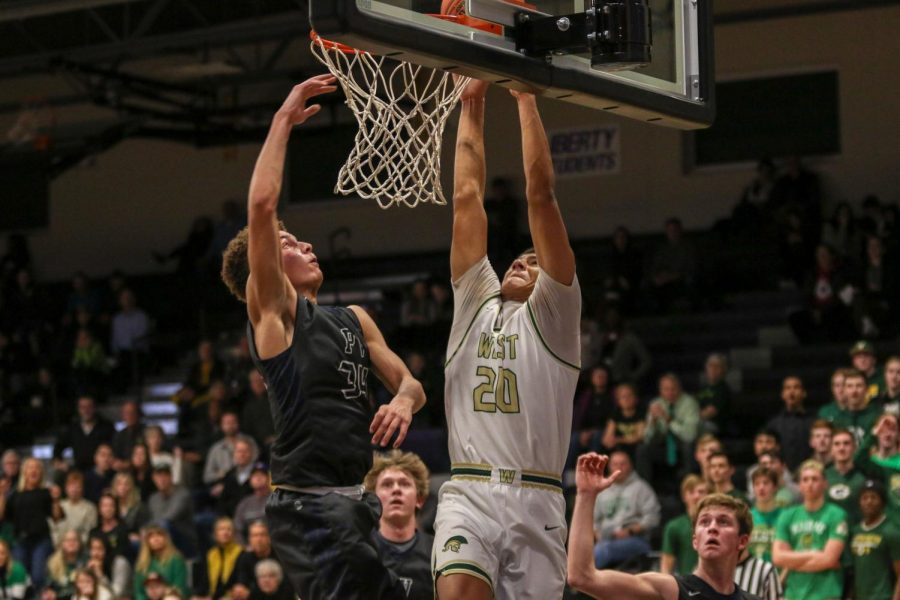 Marcus Morgan '21 goes up for a dunk against Pleasant Valley on March 3.