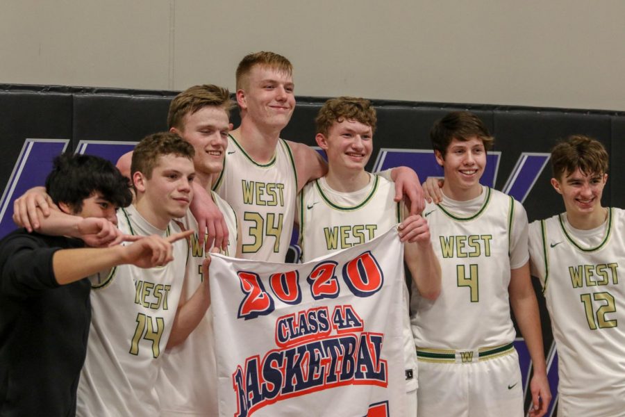 Seniors pose with the state qualifier banner after defeating Pleasant Valley on March 3.