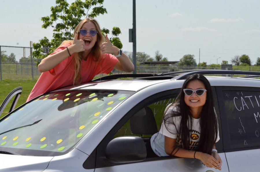 Seniors Natalie Young and Catie Miller pose during the car parade on May 31.