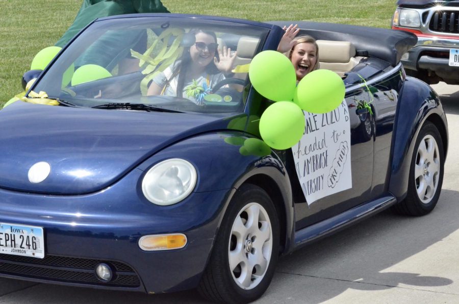 Austyn Goodale '20, a St. Ambrose University cheer and diving commit, waves from her car during the senior car parade on May 31. 