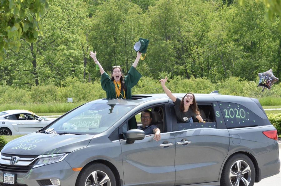 Maia DeGrazia '20 and Tess DeGrazia '23 wave from their cars during the senior car parade on May 31.