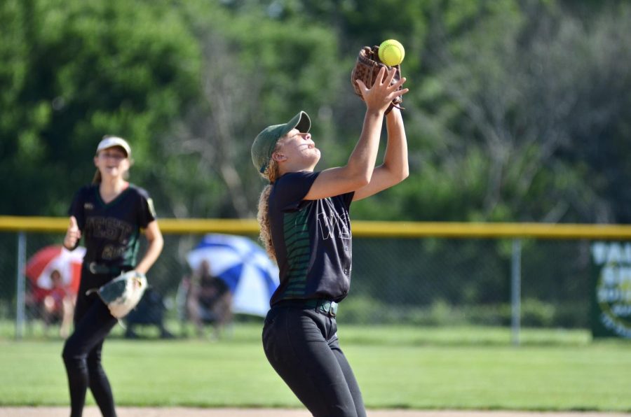 Kiahna Hill 20 catches a fly ball while playing shortstop. 