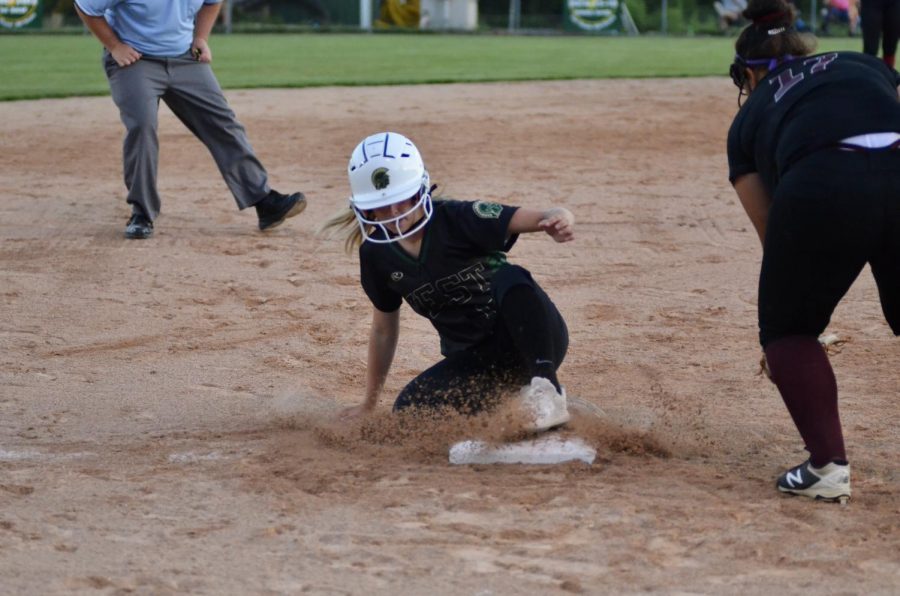 Cameron Hopkins 22 slides into third base July 16.