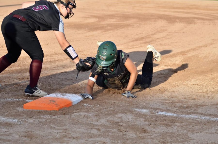 Kate Sehr '20 dives back to first on a throw down July 16.