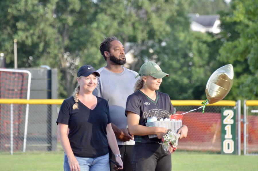 Senior Kiahna Hill stands with her parents on July 3 being honored by the players and families.