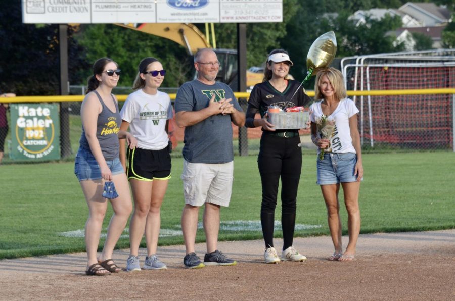 Senior Grace Schneider stands with her family July 3 during the senior ceremony.