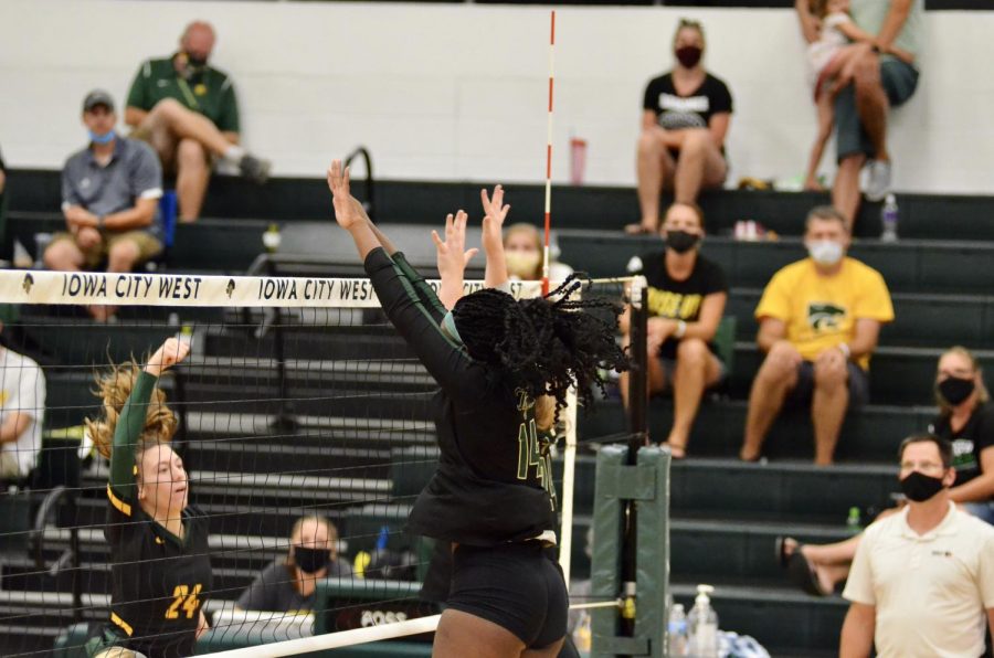 Mayowa Dokun '22 jumps for a block against Kennedy on Aug. 25.