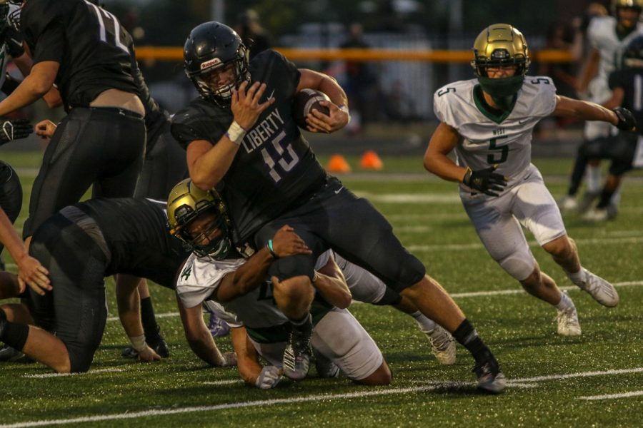 Mason Applegate '22 tackles Liberty running back Max Tafolla '21 for a loss on Aug. 28. 