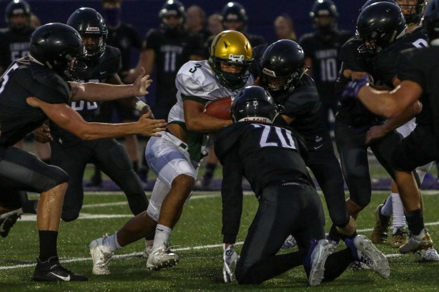 Trey King '21 runs through a group of Liberty defenders on Aug. 28.