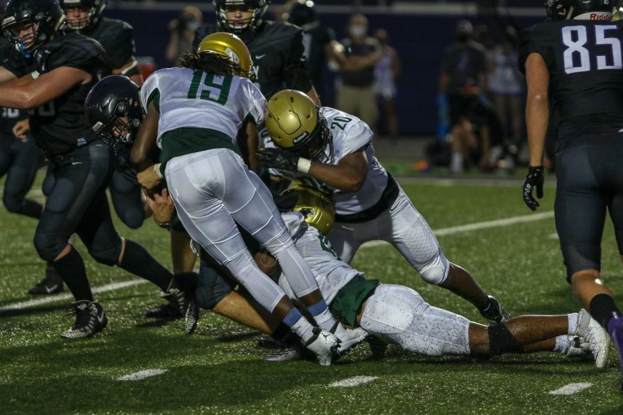 Mo Simpson '21 and Dijon Genus '21 make a tackle against Liberty on Aug. 28. 