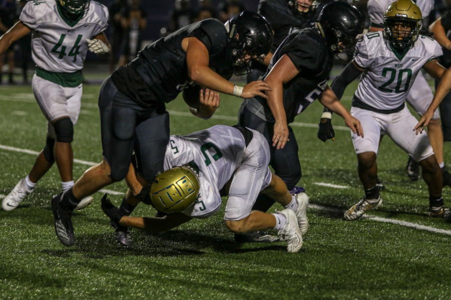 Ian McAreavy '21 makes a tackle for a loss against Liberty on Aug. 28.