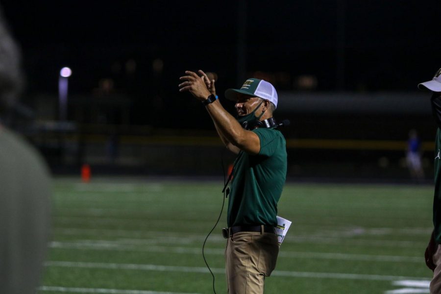 Head coach Garrett Hartwig questions a call against Liberty on Aug. 28.