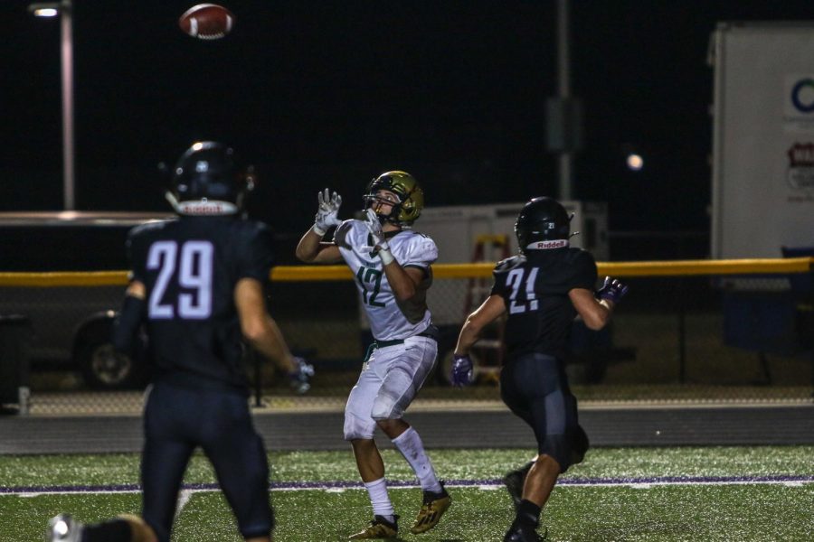 Grahm Goering '21 watches the ball in for a 22-yard touchdown grab against Liberty on Aug. 28.