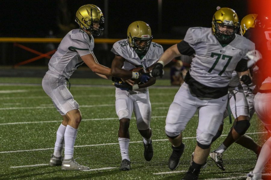 Fabian Brown '21 takes a handoff late in the game against Liberty on Aug. 28.