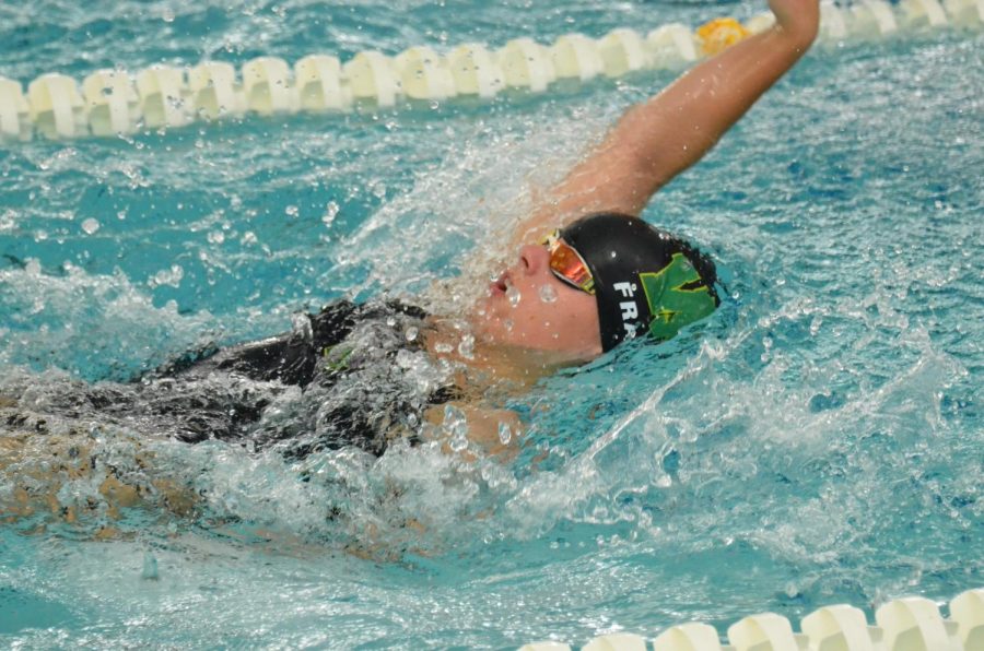 Lauren Frank 21 swims backstroke during the meet against Dubuque Wahlert Sept. 29.