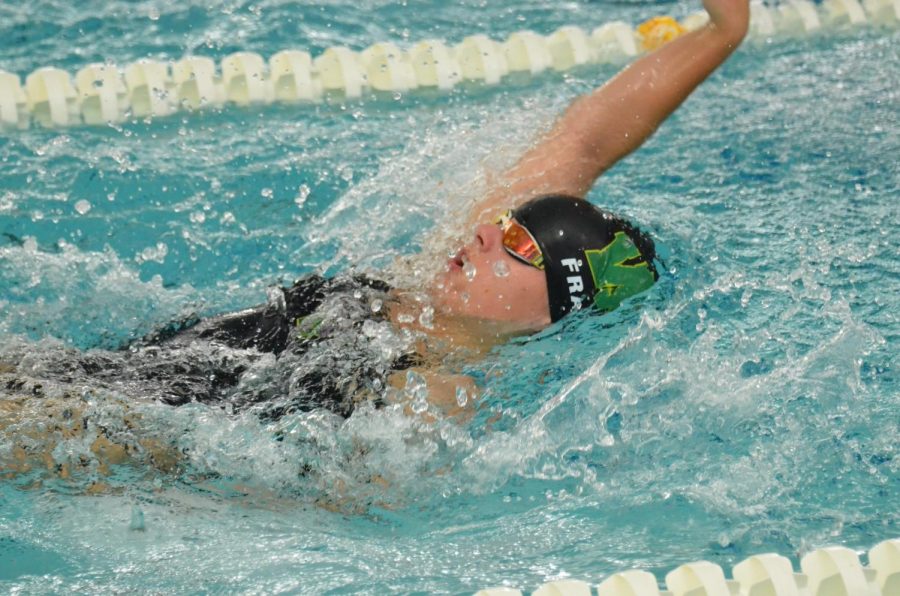 Lauren Frank '21 swims backstroke during the meet against Dubuque Wahlert Sept. 29.