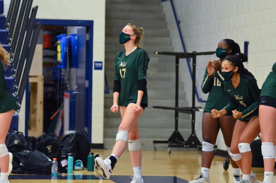 Raina Pfeifer '22 and the rest of the bench cheer as West High wins the second set Sept. 7.