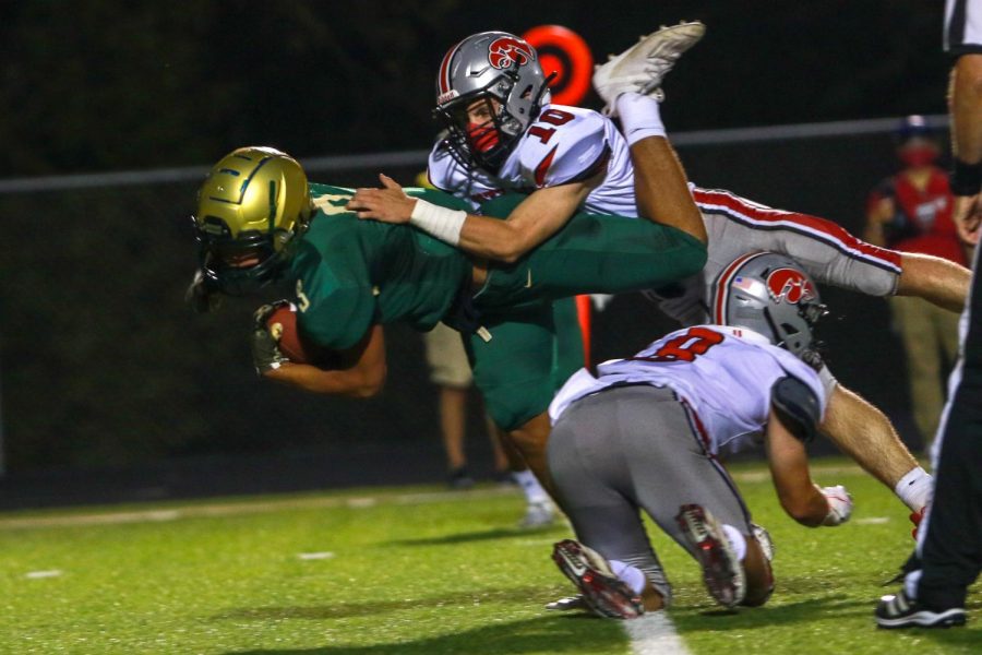 Trey King '21 leaps for a first down during the Battle for the Boot on Sept. 4.