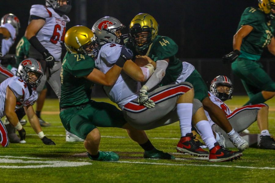 Mason Applegate '22 and Kalen Haworth '21 make a tackle for a loss during the Battle for the Boot on Sept. 4.