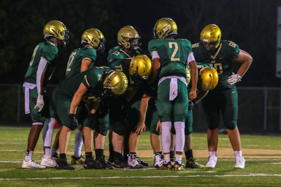 The West High offense calls a play during the Battle for the Boot on Sept. 4.