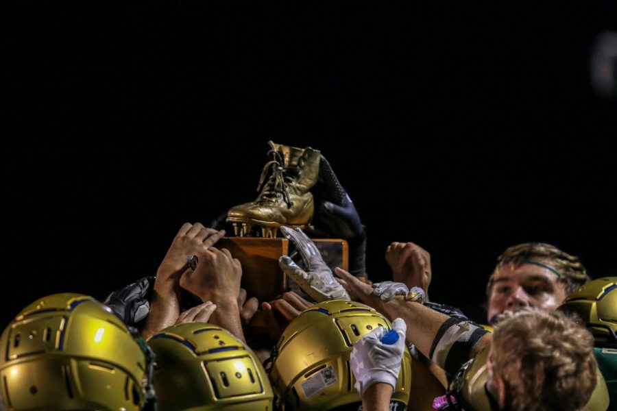 The Trojan football team celebrates with The Boot after the Battle for the Boot on Sept. 4.