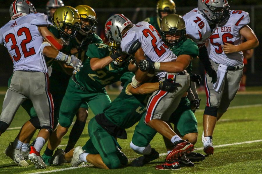 Alex McKay '21 and Ian McAreavy '21 make a tackle for a loss during the Battle for the Boot on Sept. 4.