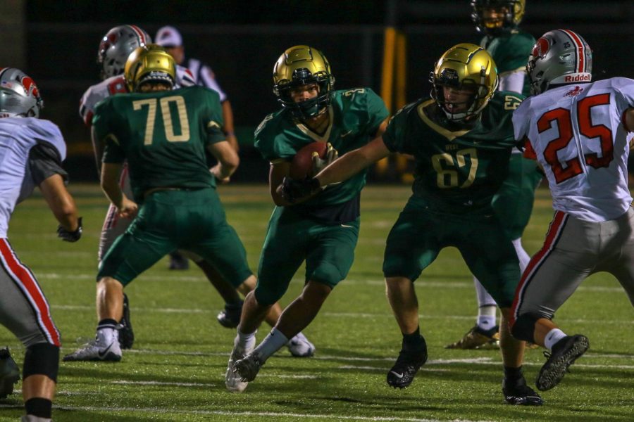 Trey King '21 follows a block for extra yards during the Battle for the Boot on Sept. 4.