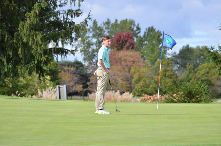 Caleb Kirk 21 waits with his ball marker in place as he finishes up on the 9th hole at Pleasant Valley.