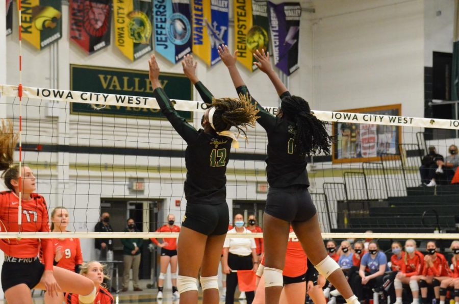 Melae Lacy 24 and Mayowa Dokun 22 block a hit from City High. 