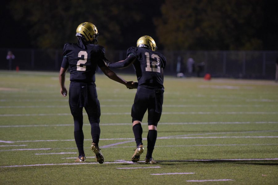 Marcus Morgan ‘21 congratulates Grahm Goering ‘21 after a successful touchdown against Kennedy on Oct. 10.