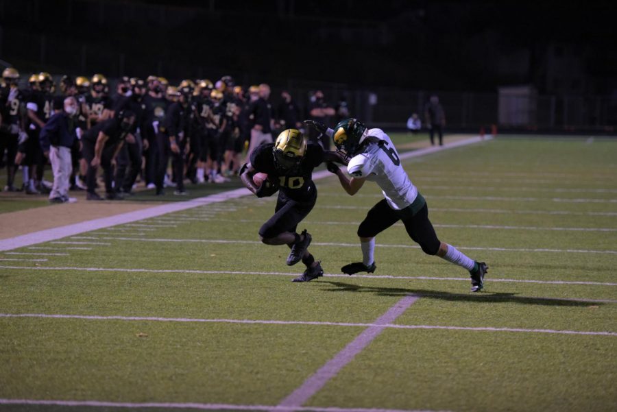 Damarian Williams 21 drives past Zane Hill 21 for a touchdown against Kennedy on Oct. 10.