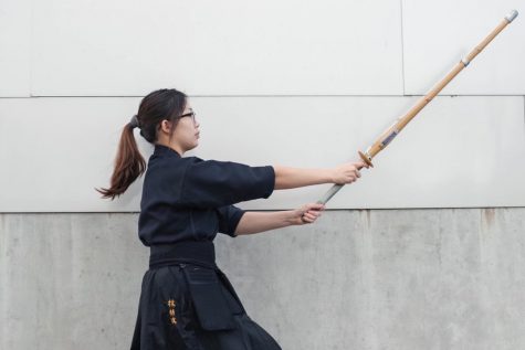 Jimin Seo 22 casts her bamboo sword forward as she stretches her arms to perform her strike.