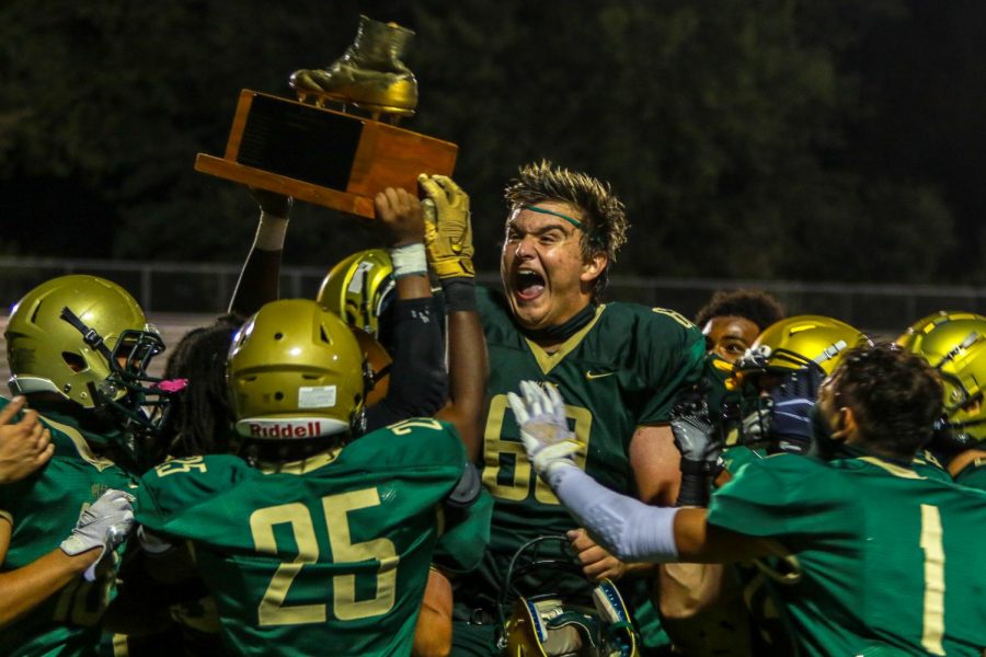 Liam Becher '22 and the varsity football team celebrate their win at the Battle of the Boot Sept. 4. West defeated City 56-20. 