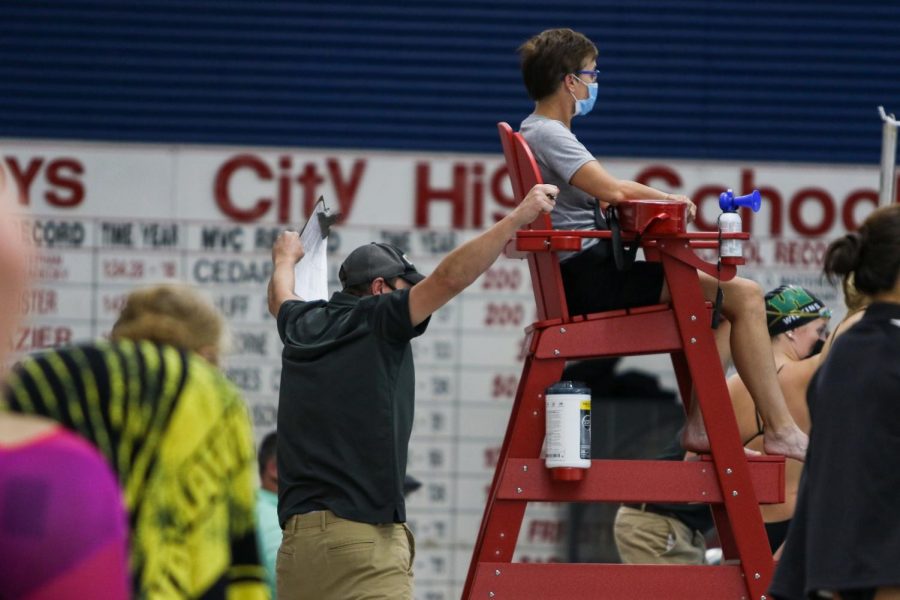 Head coach Byron Butler cheers on his swimmers from the edge of the pool at the Mercer Park Aquatic Center Oct. 17.