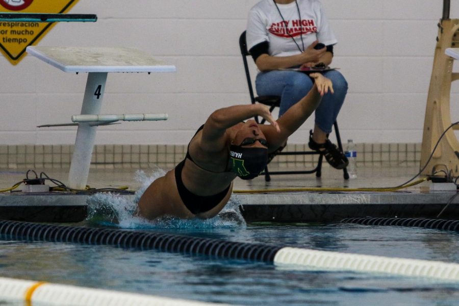 Junior Scarlet Martin pushes off of the wall at the start of the 100 backstroke at the Mercer Park Aquatic Center Oct. 17. Martin broke her own meet record with a time of 56.82.