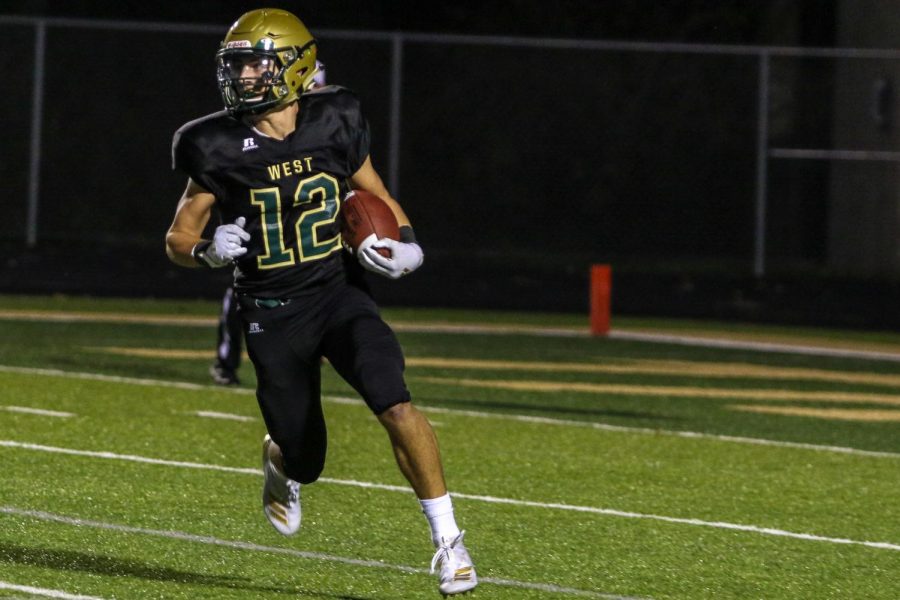 Grahm Goering '21 returns a kickoff during the team's game against Dubuque Senior at Trojan Field on Sept. 20.