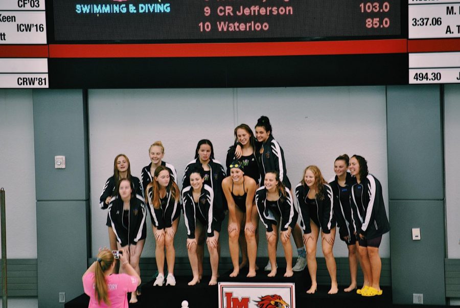 Greta Kraske 23 and the Iowa City West girls swim team after they placed first during a conference meet at Linn-Mar on October 26, 2019.