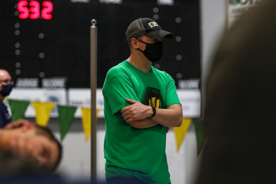 Byron Butler eyes his swimmers against Waterloo on Dec. 15 at the Coralville Rec Center.