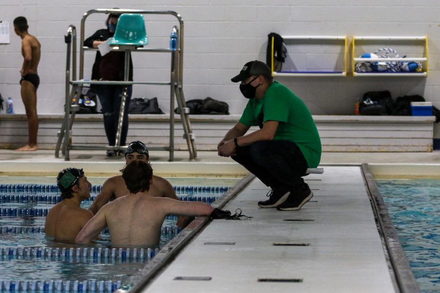 Head coach Byron Butler talks with some of his swimmers during a break on Dec. 15 at the Coralville Rec Center.