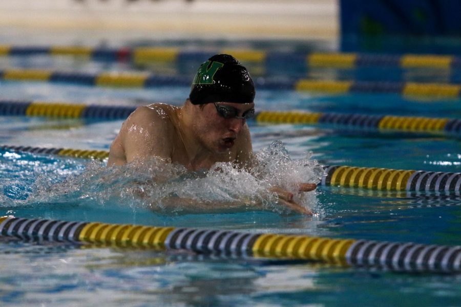 Jordan Christensen '22 swims in the 200 IM against Waterloo on Dec. 15 at the Coralville Rec Center.