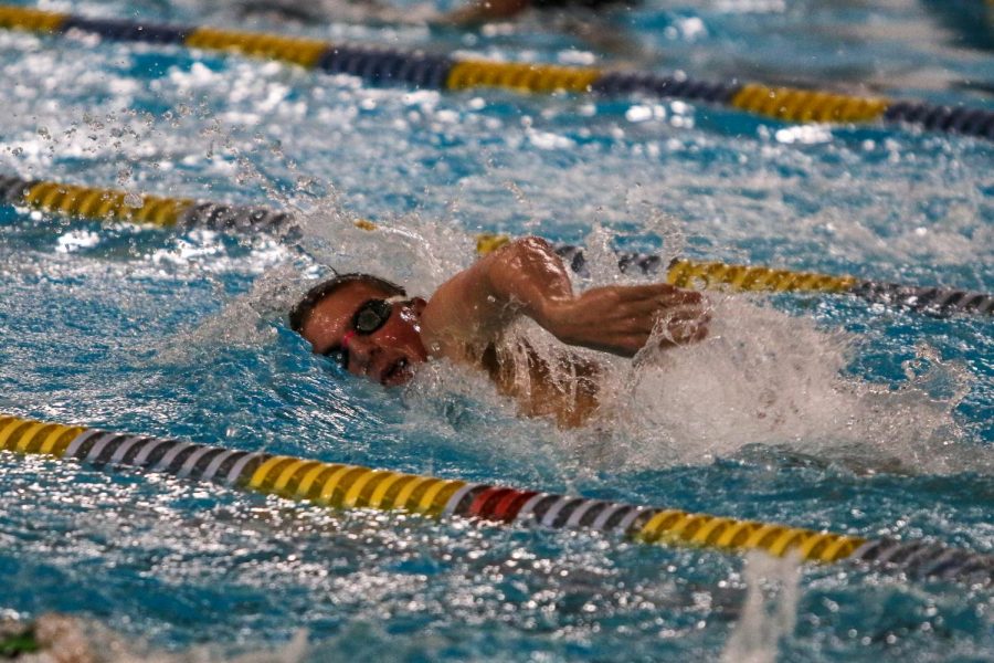 Max Gerke '24 swims in the 500 Freestyle against Waterloo on Dec. 15 at the Coralville Rec Center.