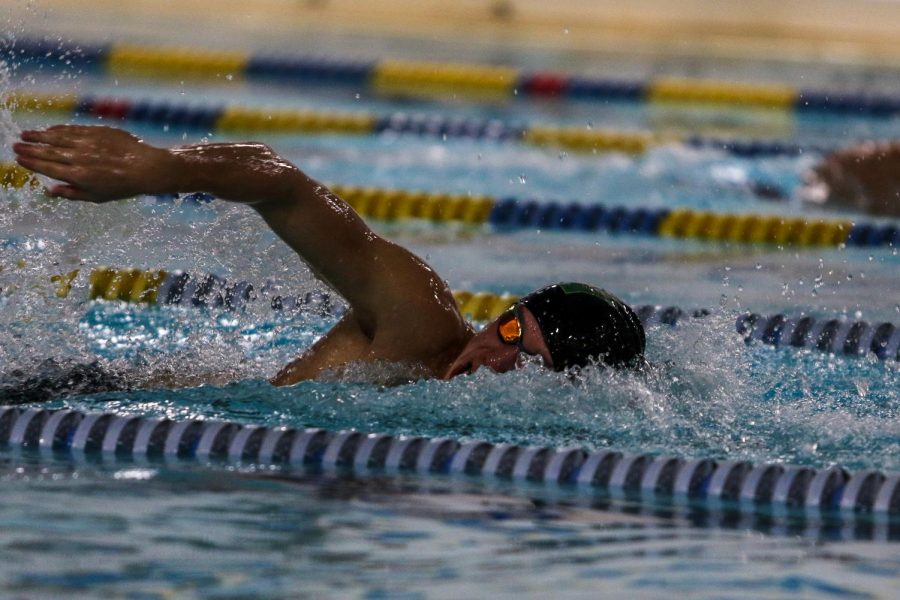 Holden Carter '24 swims in the 400 Free Relay against Waterloo on Dec. 15 at the Coralville Rec Center.