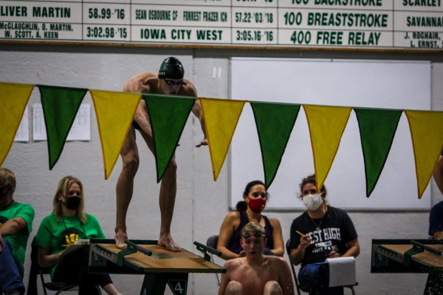 Boyd Skelley '22 prepares to dive in during the 400 Free Relay against Waterloo on Dec. 15 at the Coralville Rec Center.