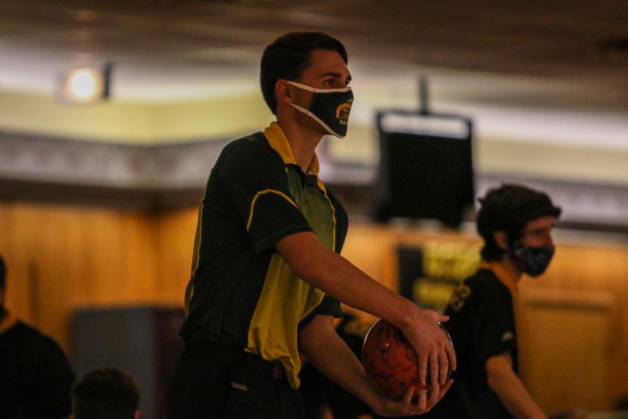 Ryan Bys '22 eyes the pins while bowling against Kennedy on Dec. 18.