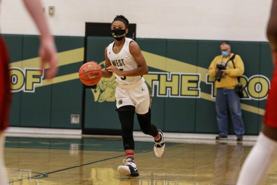 Emma Ingersoll-Weng '22 brings the ball up the floor against City High on Dec. 18.